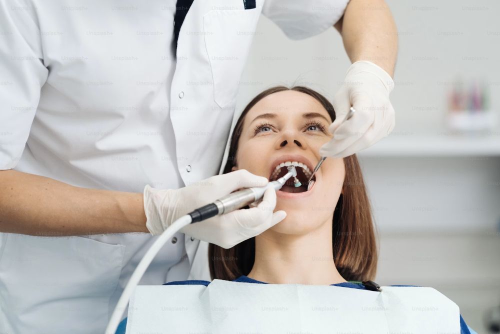dentist performing composite filling treatment on a patient