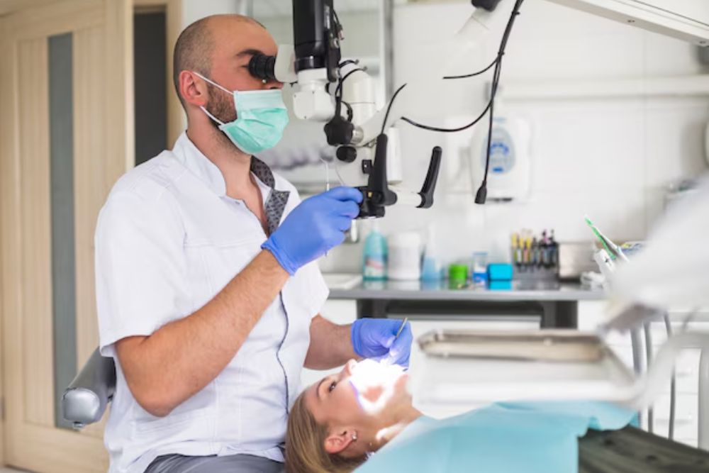 dentist examining a damaged tooth to compare root canal and extraction options