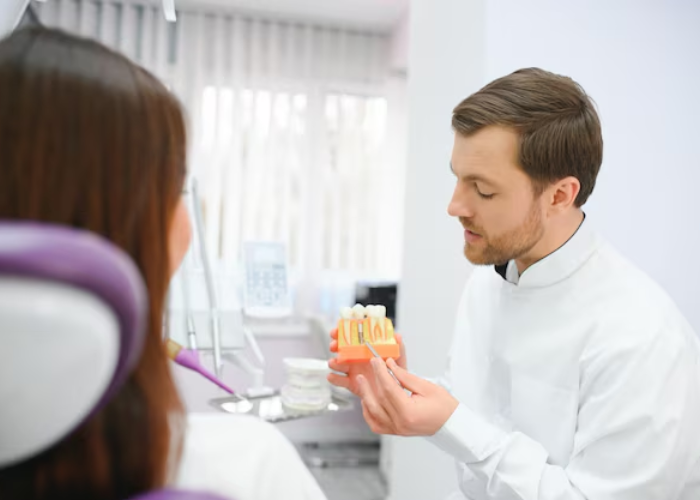 dentist examining a dental crown to check its fit and condition.